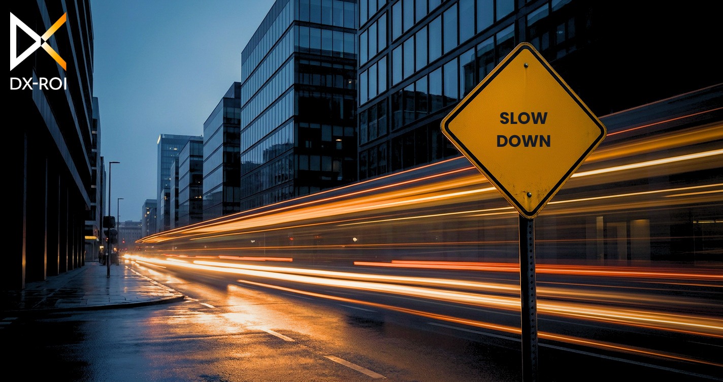 DX-ROI A yellow “SLOW DOWN” road sign stands on a city street at night, with long-exposure light streaks from moving traffic.